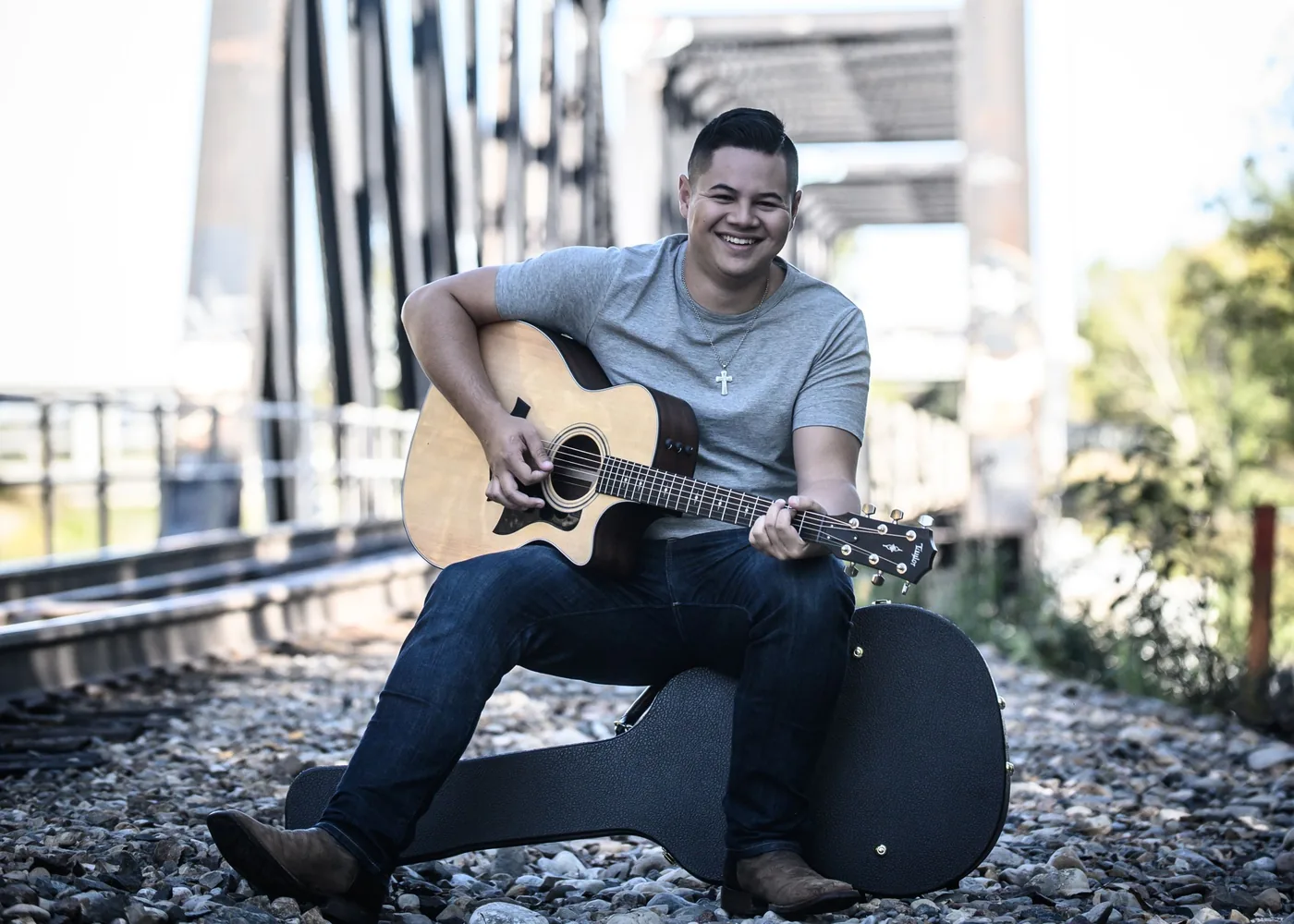 Brandon Lorenzo with an acoustic guitar