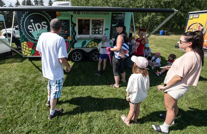 A family visiting a food truck at the 2025 festival