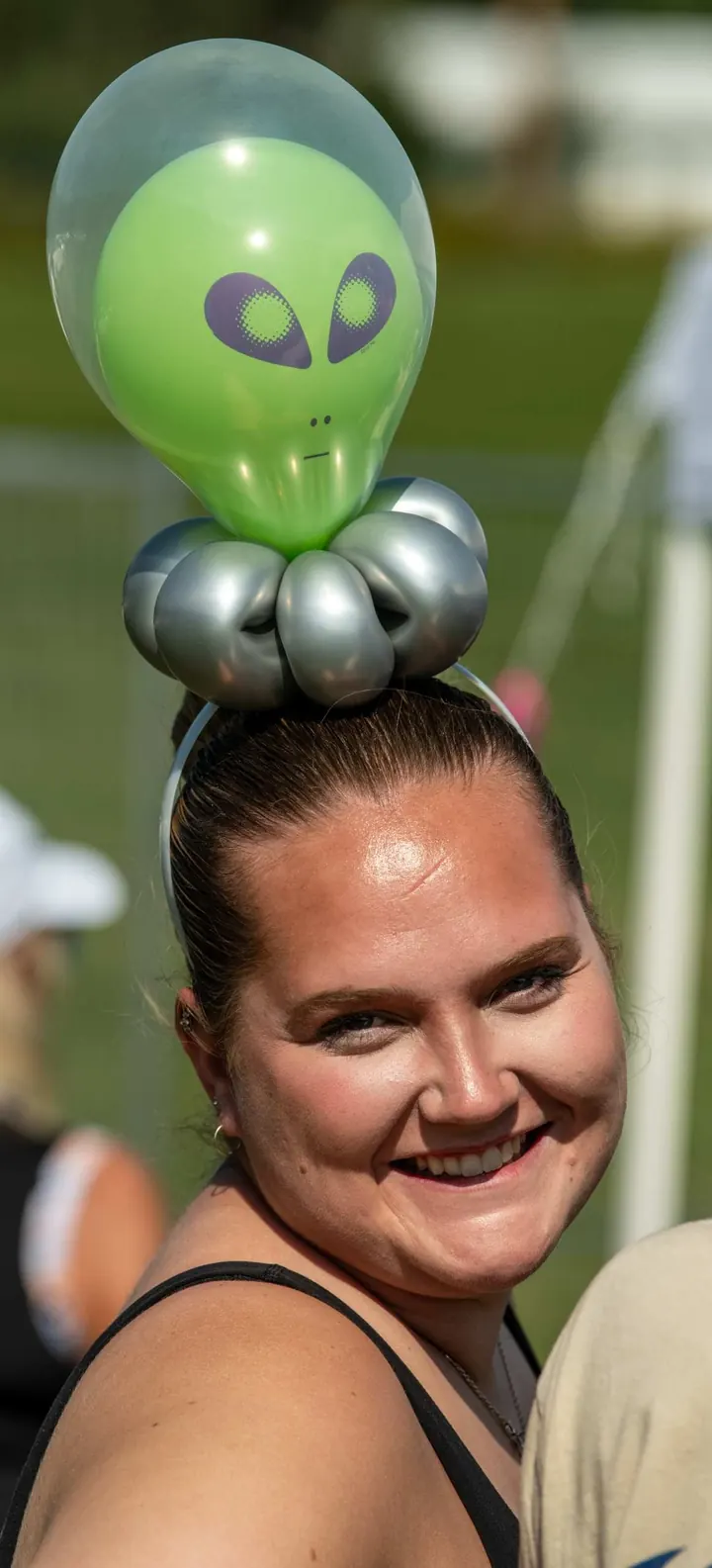 A balloon artist entertaining children at the 2025 festival