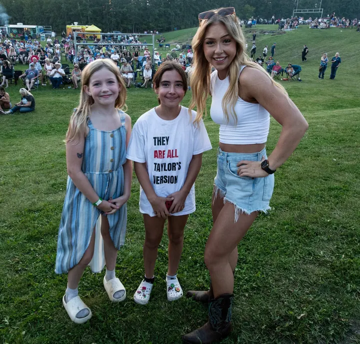 Children gathered with a festival performer in 2025